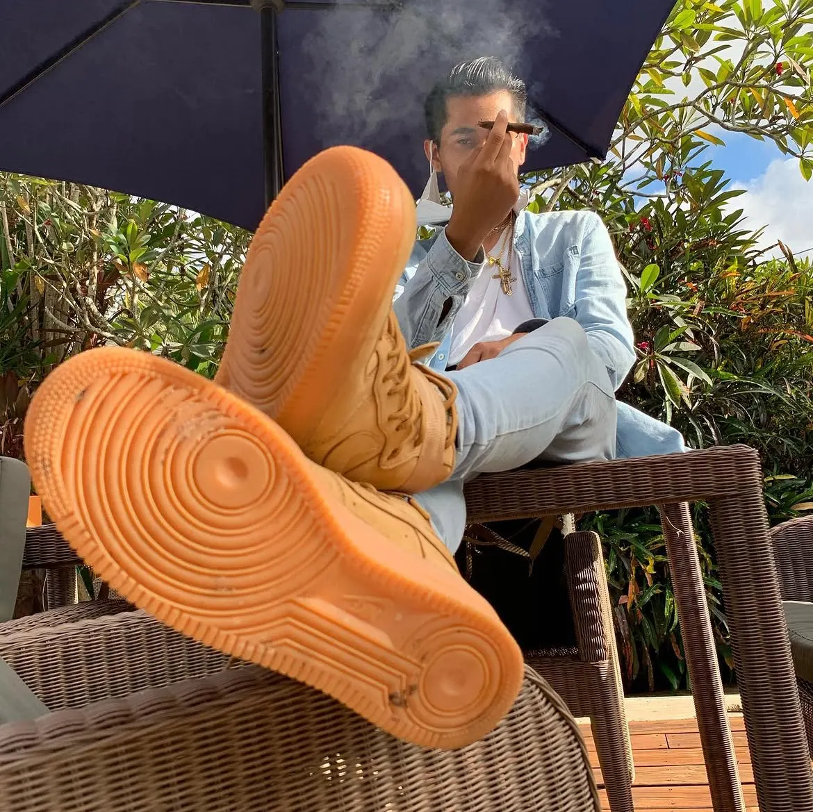 John Caicedo with his sneakers up on a patio table